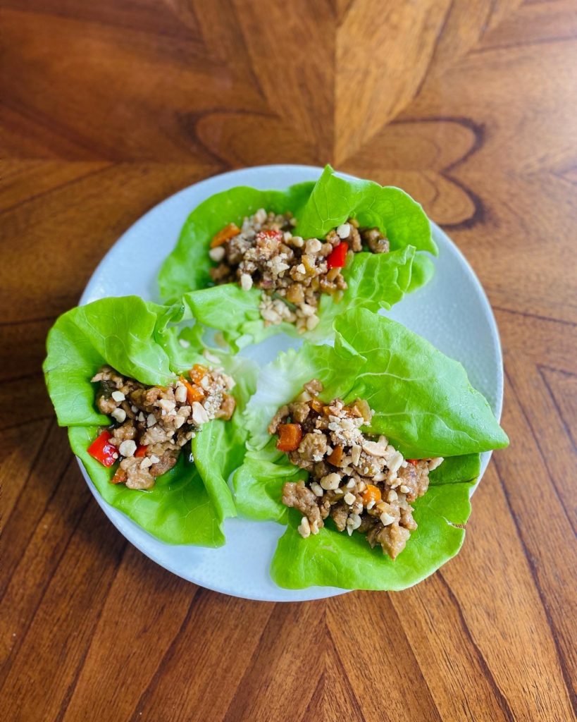 Plate of bright green lettuce wraps with ground turkey. 